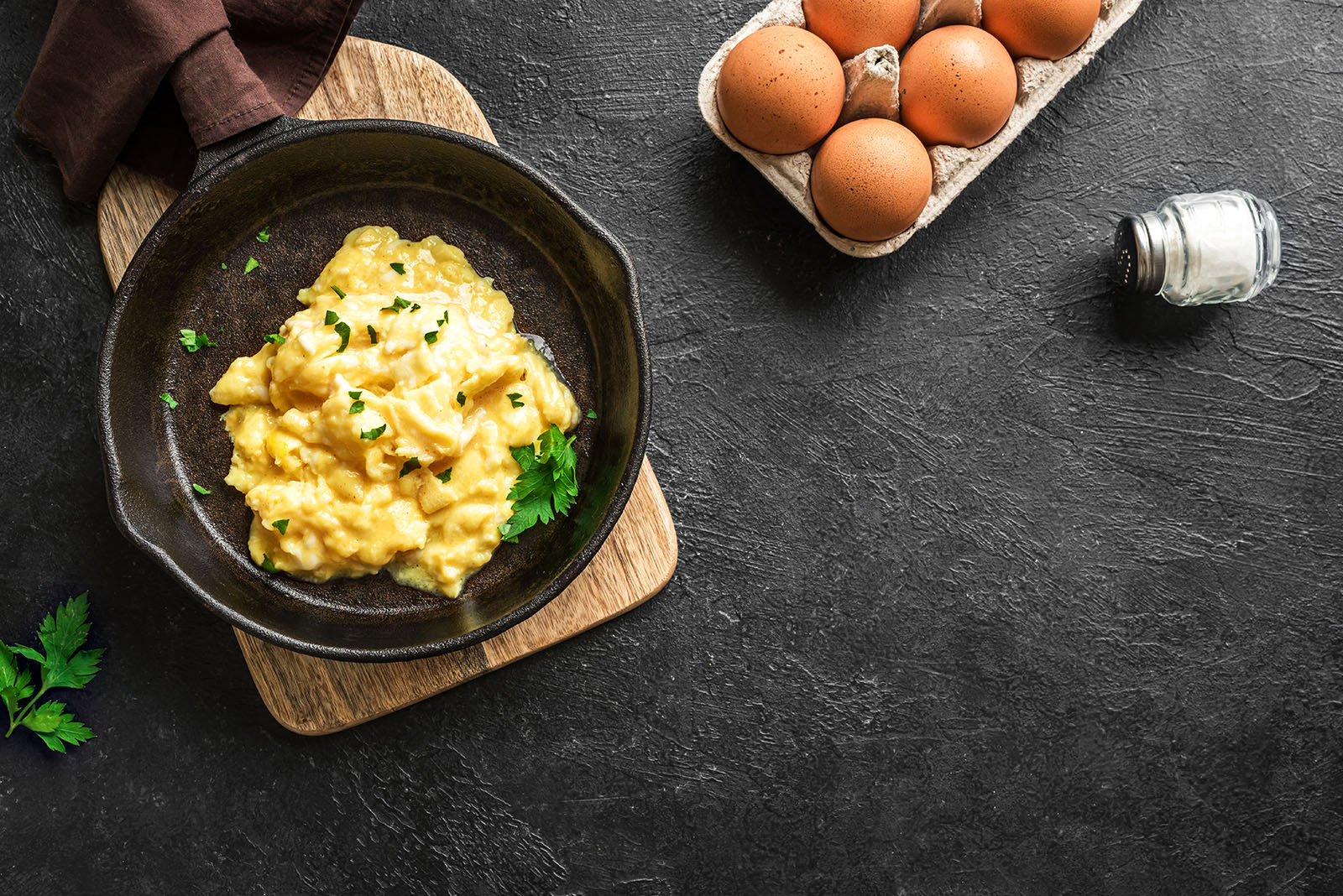 Scrambled egg in a cast iron pan.