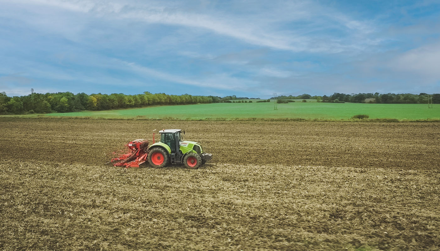 Tractor moving along field.